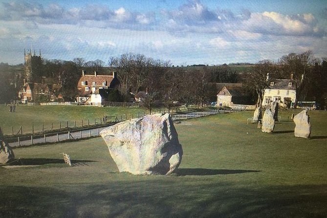 Avebury stone circle with the village rooftops and church tower behind the stones