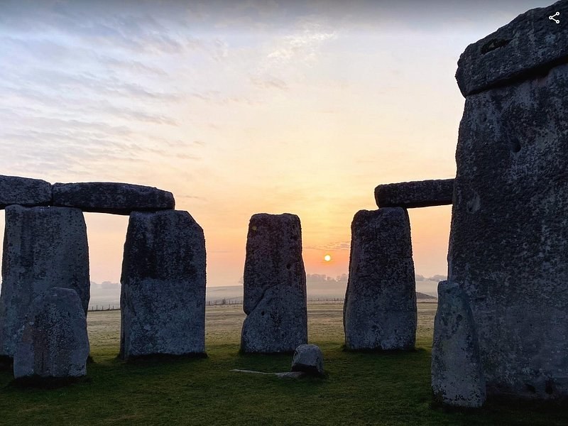 Sunrise breaking behind the Stonehenge trilithons