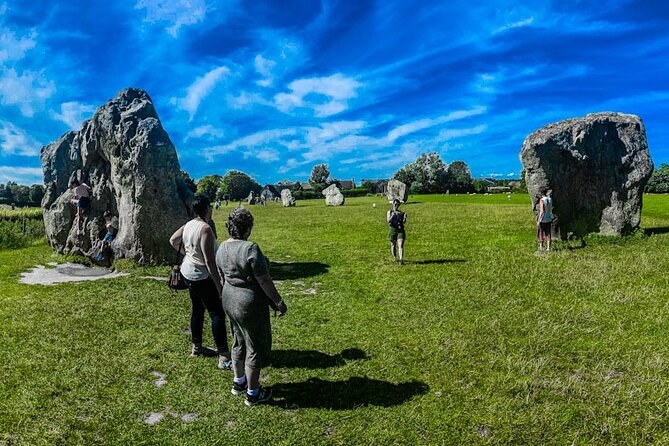 Visitors walking freely among the stones at Avebury, where there are no ropes